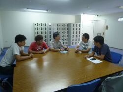 A teacher visits students on a summer internship at the Tainan plant of Toppan Ltd.
