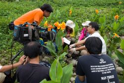 Department chair Lin Ying-Feng introduces CNU's artificial wetlands for a PTS television program