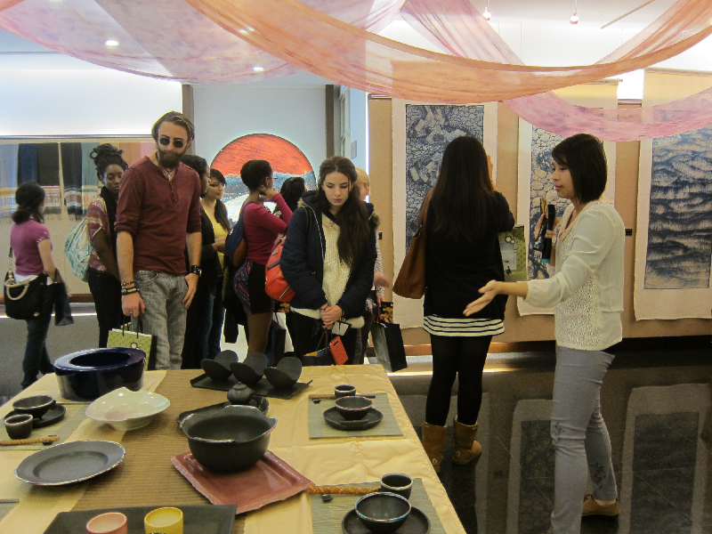 Visiting students from the University of St. Thomas, Texas, are given a guided tour of a handicraft exhibition in the CNU Center for Arts and Culture.