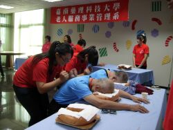 Students participating in a massage service activity for the elderly